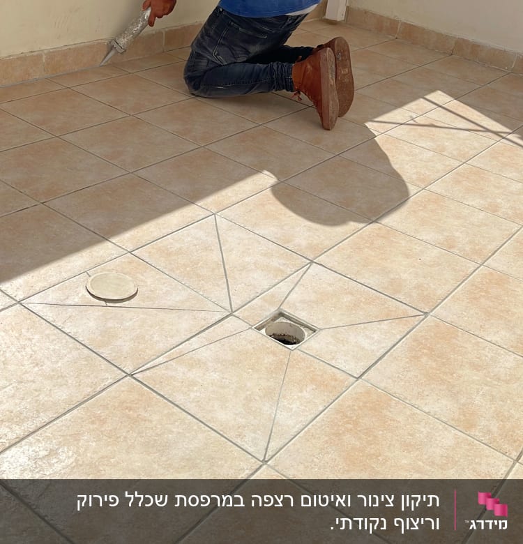 אדם מורח חומר איטום על רצפת אריחים